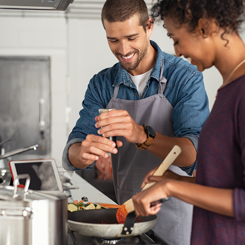 Man adding pepper in tomato sauce